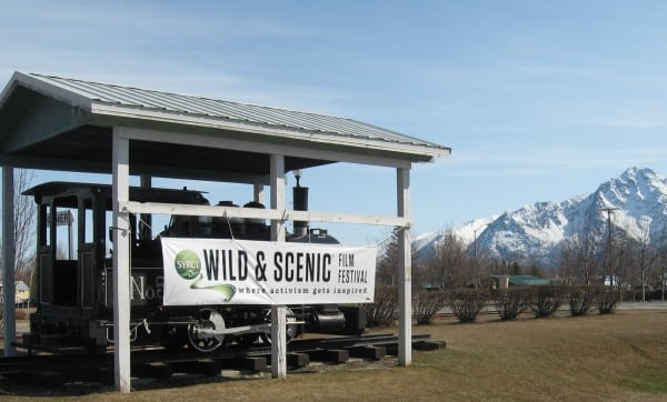 A Wild & Scenic Film Festival banner hanging over a train.