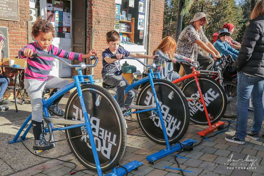 Children and adults riding bicycles to provide power to one of our stages